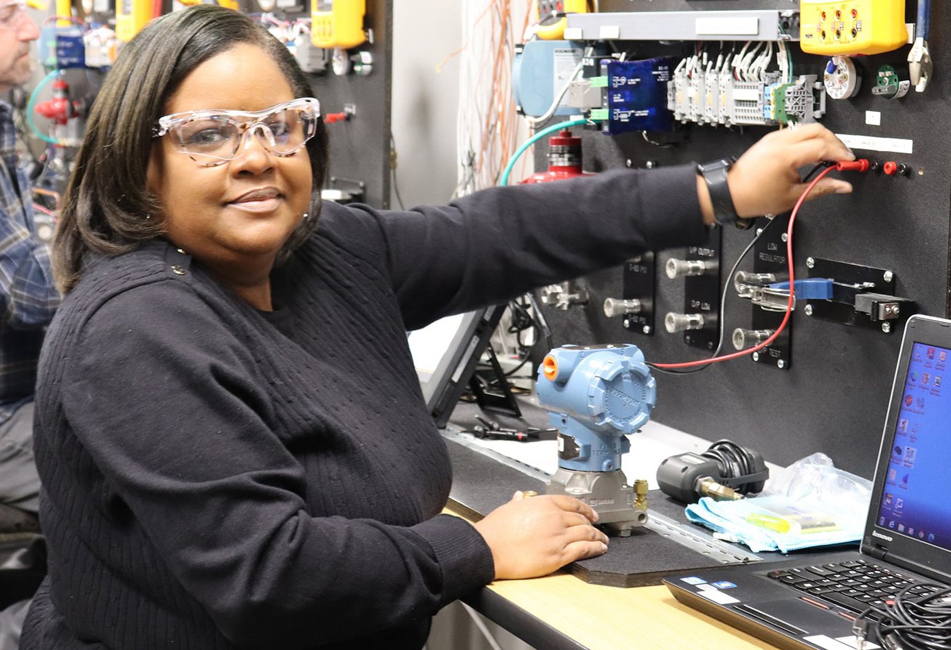 black woman smiling at camera while touching a lab instrumentation training board-3